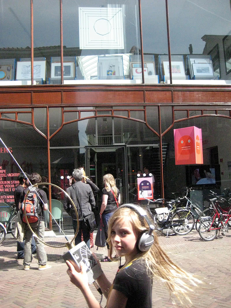 Radioscape - young participant with a dedicated receiver and in the background one of the transmitter antennas